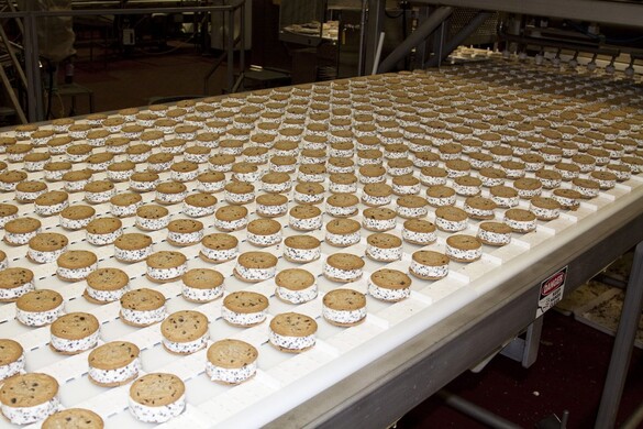 Ice cream treats on a conveyor belt in a factory