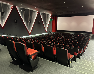 Red theater seats inside the large auditorium at the Varsity Cinema