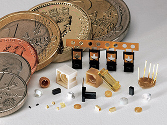 Small molded pieces shown next to coins for scale