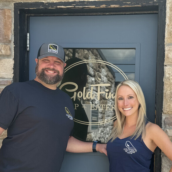 Owners of the GoldFinch Tap standing in front of their business' door