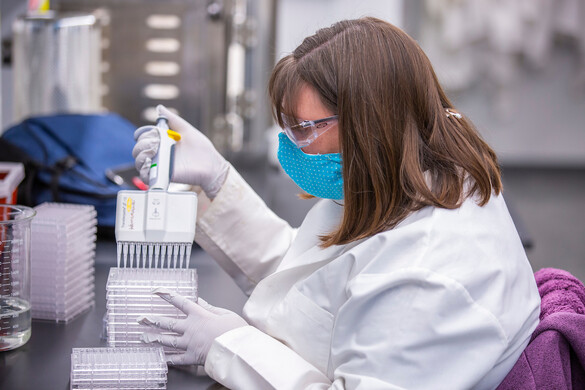 Masked scientist working in a lab