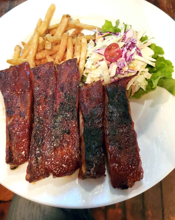 Ribs on a plate with coleslaw and fries