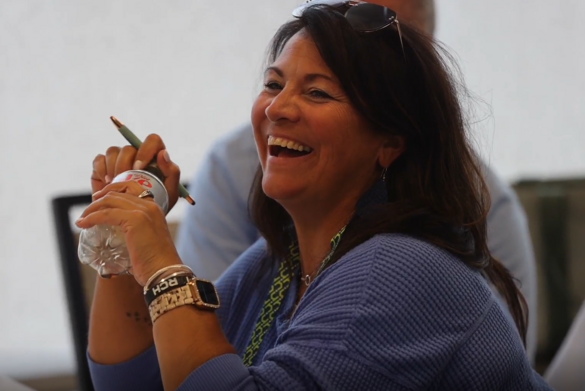 woman wearing blue and laughing