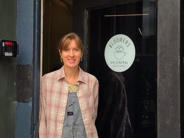 a woman standing in front of a storefront