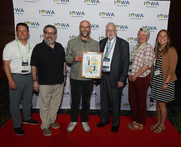 group of people from The Delaware posing with an award
