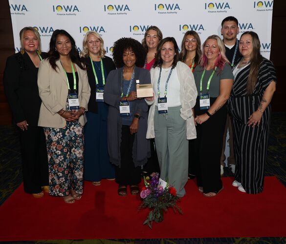 New Visions team posing with an award