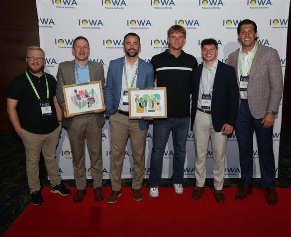 group of people from the view posing with an award