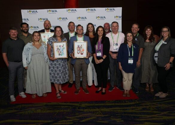 Group of people from the Veterans District posing with an award