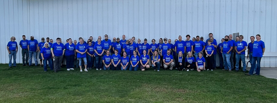Team members from AAI/Spalding wearing blue shirts in a group photo